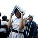 A graduate tries to stay dry after commencement on Monday, June 10. Daniel Brenner I AnnArbor.com